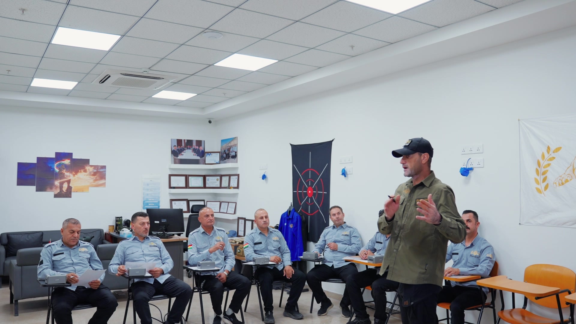 A Harekar instructor briefing a team of guards